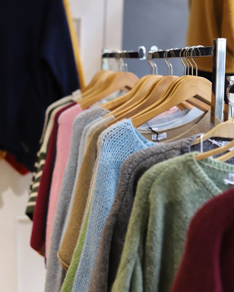 A rail of soft new-season knitwear in pinks, blues and greens.