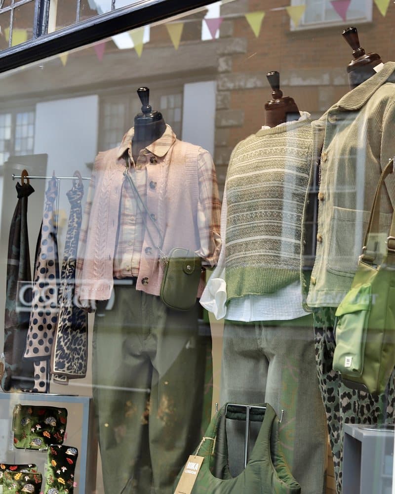 An Oberon window display with mannequins in knitwear and soft trousers.